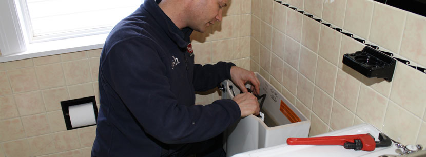 Carl is repairing the float on a toilet