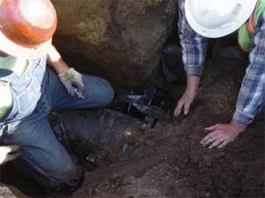 two of our specialists are working on a sewer repair